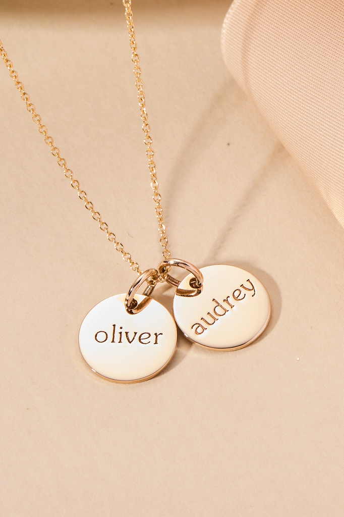 gold circle necklace with names on front engraving