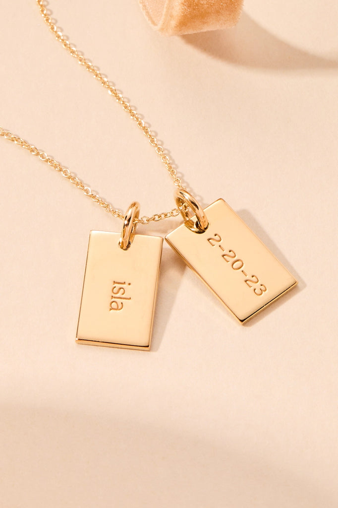 gold mini dog tag with front and back engraving