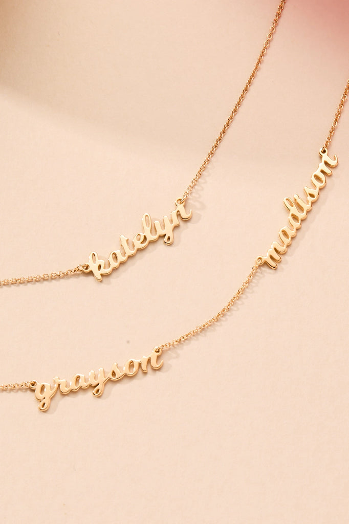 assorted gold nameplate necklaces