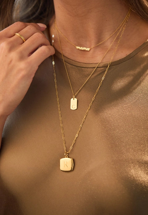 woman wearing gold necklace stack